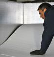 contractor installing TerraBlock™ floor insulation in a New City crawl space