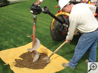 Auguring a hole in the earth for a foundation repair in Suffern