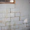 A cracked foundation wall near a window in a Highland home