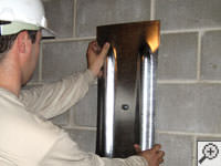 Mounting a foundation wall plate for an earth anchor installation in New Windsor.