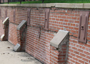 Rusted wall plate anchors in a retaining wall repair in Walden.