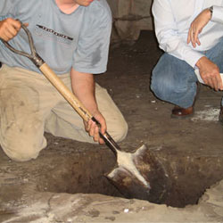 Digging a hole for the engineered fill used in a crawl space support system installation in Wappingers Falls
