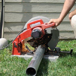Cutting the support beam for a crawl space jack post outside a New City home.