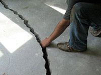 a severely damaged cracked concrete slab floor in Pearl River