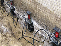 Using foundation push piers to lift a foundation during a repair in Nanuet.