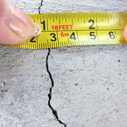 A crack in a poured concrete wall that's showing a normal crack during curing in Goshen