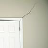 A long drywall crack beginning at the corner of a doorway in a Pearl River home.