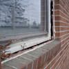 A gap in a window along the outer wall due to foundation settlement of a Saugerties home.