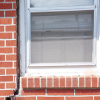 A gap in a window along the outer wall due to foundation settlement of a Saugerties home.