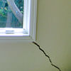 A long, diagonal crack that begins at a window corner of a Nyack home