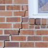 long jagged cracks starting at the corner of a window along a brick wall on a New Paltz home