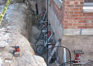 Foundation push piers installed around a house with a foundation settlement issues in Red Hook