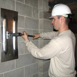 installing a wall anchor to repair an bowing foundation wall in Nanuet