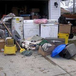 Soaked, wet personal items sitting in a driveway, including a washer and dryer in Wappingers Falls.