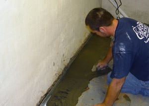 Restoring a concrete slab floor with fresh concrete after jackhammering it and installing a drain system in Stony Point.