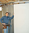 Installing wall panels on top of our basement wall insulation in Wappingers Falls