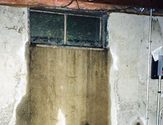 Water pouring out from a basement window in Monroe